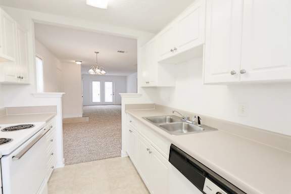 White kitchen with steel sink at Sanctuary Apartments and Townhomes, Augusta Georgia