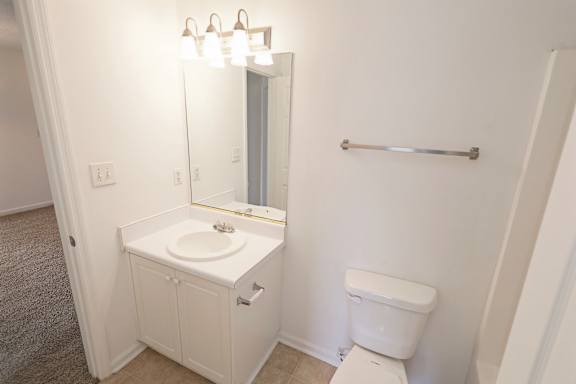 Calm neutral bathroom with carpet flooring at Sanctuary Apartments and Townhomes, Georgia, 30909