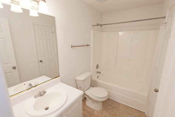 Sophisticated bathroom with glossy mirror wall at Sanctuary Apartments and Townhomes, Georgia