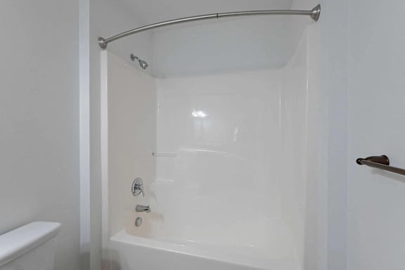 a white bathroom with a shower and a tub at Sterlington Apartments, Georgia, 30813