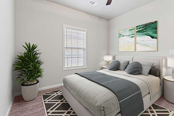 Blue pillows on bed at The Vista Apartments &amp; Townhomes, Warrenville, SC