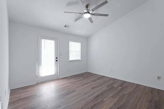 an empty living room with white walls and a ceiling fan at Sterlington Apartments, Grovetown, GA