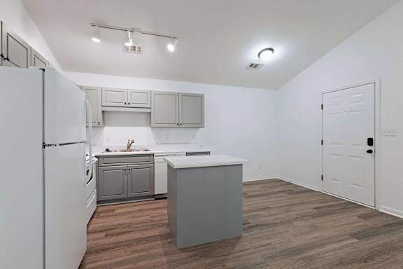 an empty kitchen with a refrigerator and a sink at Sterlington Apartments, Georgia