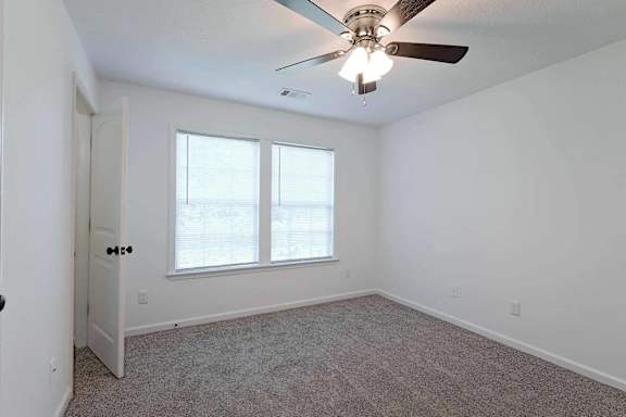 a bedroom with a large window and a ceiling fan at Sterlington Apartments, Georgia, 30813