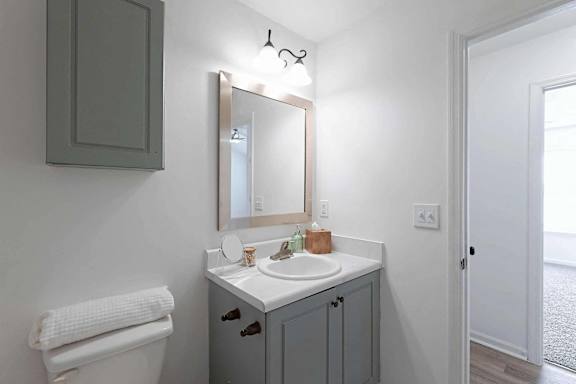 a bathroom with a sink and a mirror at Sterlington Apartments, Georgia