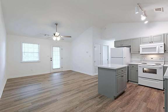 an empty kitchen and living room with a ceiling fan at Sterlington Apartments, Grovetown, GA, 30813
