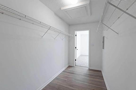 an empty room with white walls and a door to a closet at Sterlington Apartments, Grovetown, Georgia