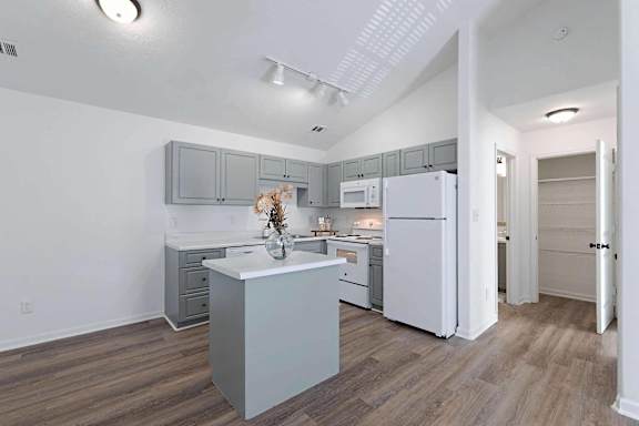 a kitchen with white cabinets and a white refrigerator at Sterlington Apartments, Georgia, 30813