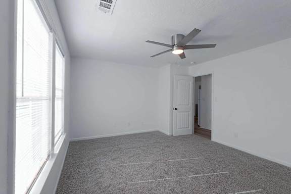 an empty living room with a ceiling fan and a window at Sterlington Apartments, Grovetown, GA, 30813