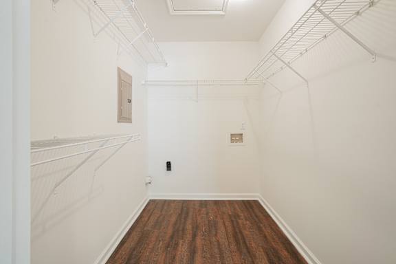 A room with white walls and a brown floor.