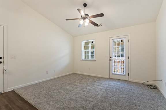 A room with a ceiling fan and carpeted floor.