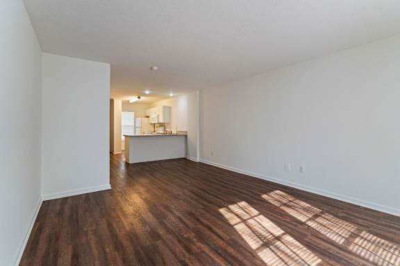 A room with wooden floors and white walls.