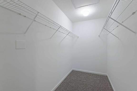 a spacious closet in a white room with white walls and a white walled closet at Sterlington Apartments, Georgia