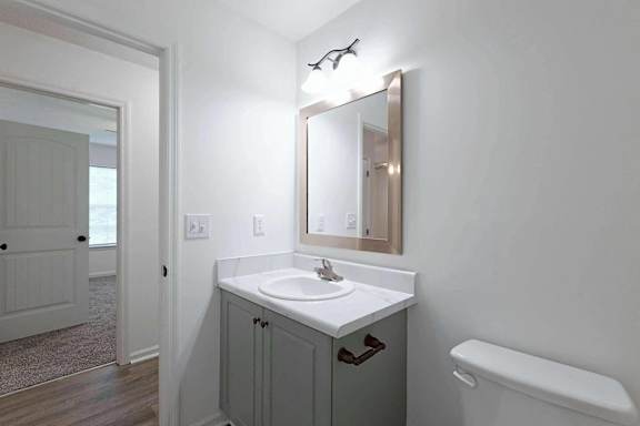 a bathroom with a sink and a mirror at Sterlington Apartments, Grovetown, GA, 30813