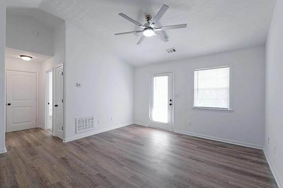 an empty living room with white walls and a ceiling fan at Sterlington Apartments, Grovetown