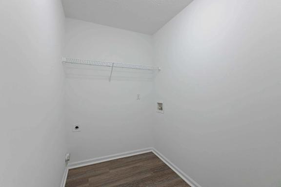 a room with white walls and a wood floor and a white closet at Sterlington Apartments, Grovetown