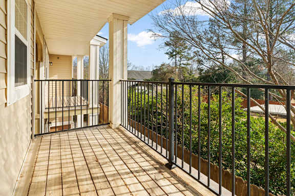 A balcony with a black railing and a tiled floor at Helena Springs, Georgia