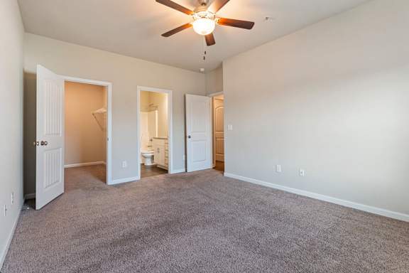 A room with a ceiling fan and carpeted floor at Helena Springs, Georgia
