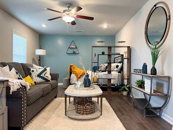 Living and sleeping area in studio apartment with accent wall at The Vista Apartments &amp; Townhomes, South Carolina