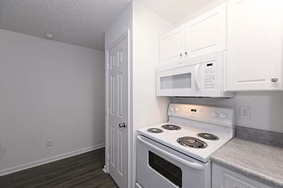 Open-plan kitchen with appliance arrangement at Sanctuary Apartments and Townhomes, Augusta, GA