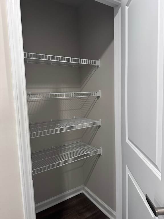 Empty shelves in a white refrigerator.