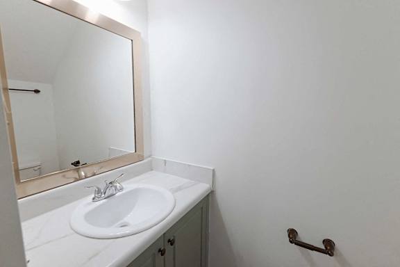 Bathroom with framed mirror at Sterlington Apartments, Grovetown, GA