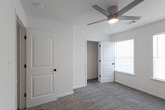 bedroom with ceiling fan and closet at Sterlington Apartments, Grovetown