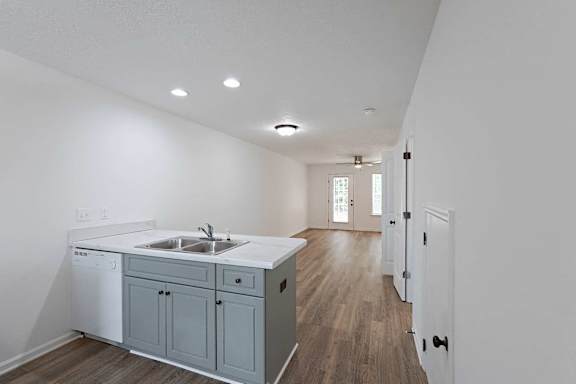 Kitchen area and living room with hardwood-style flooring throughout at Sterlington Apartments, Grovetown, GA