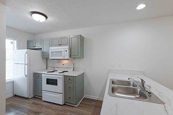 Kitchen area with white appliances at Sterlington Apartments, Georgia, 30813