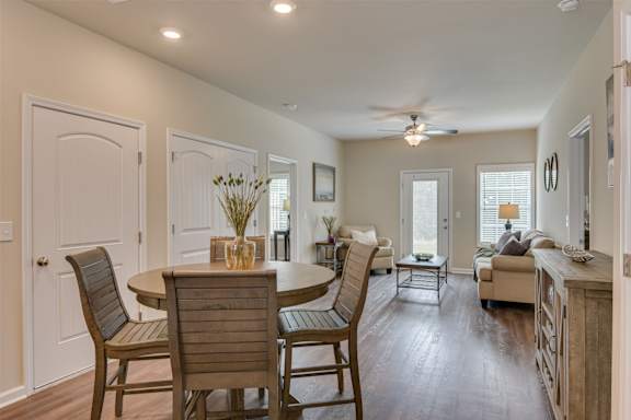 a dining room and living room with a table and chairs at The Vista Apartments &amp; Townhomes, Warrenville, SC