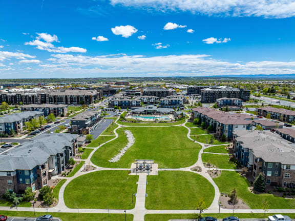 an aerial view of a city park with houses and green grass at Arbour Commons, Westminster, Colorado