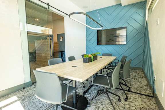 A conference room with a long table and chairs. at Arbour Commons, Westminster, CO
