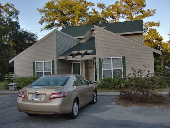 A beige Toyota car is parked in front of a house at Diamond Townhomes, South Carolina