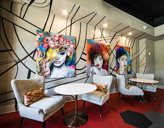 Collaboration room with art on the wall and chairs with a table in front of them at the Collective NoDA Charlotte NC