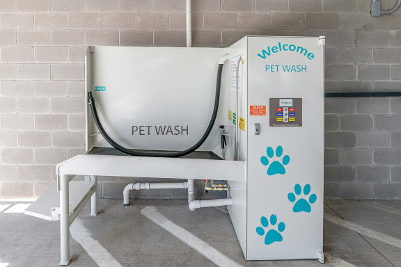 a pet wash machine with a bench next to it