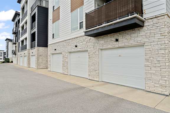 a building with white garage doors on the side of it