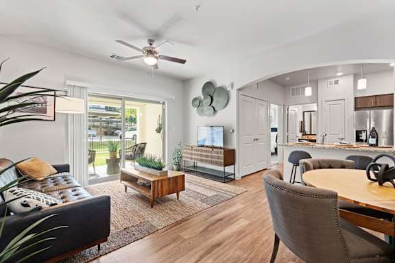 a living room with furniture and a ceiling fan