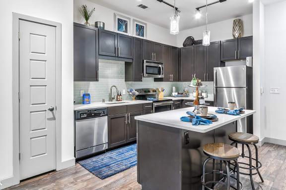a view of a kitchen with a sink and a counter top with a bunch of