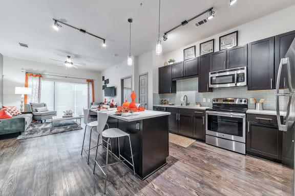 an open kitchen and living room with a table and chairs