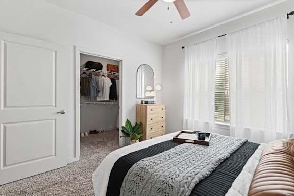 a bedroom with a bed and a closet