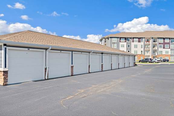 a row of garage doors in front of an apartment building