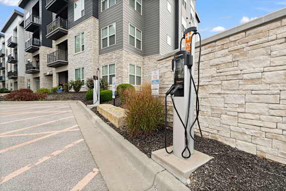 a gas pump in front of an apartment building