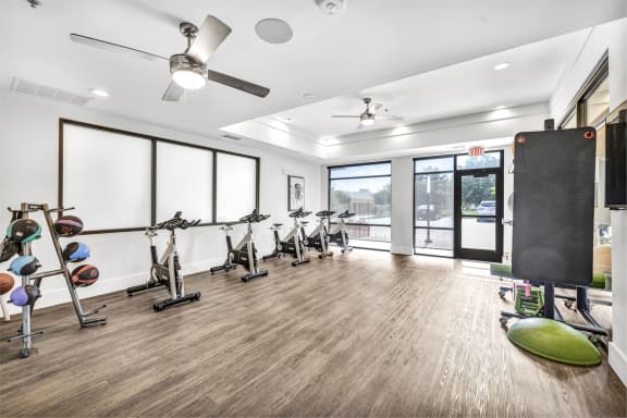 a workout room with treadmills and other exercise equipment