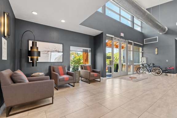 a lobby with couches and chairs and a bike parked in front of a building