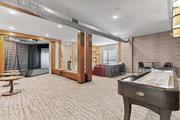 a game room with a pool table and a bar
