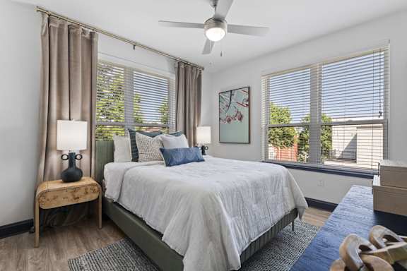a bedroom with a bed and a ceiling fan