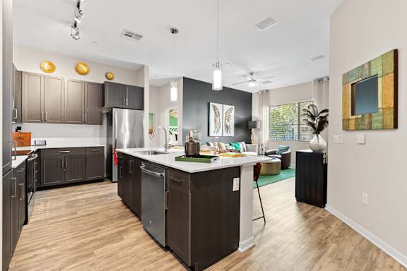 a kitchen with a large island and a living room