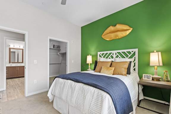 a bedroom with a green wall and a bed