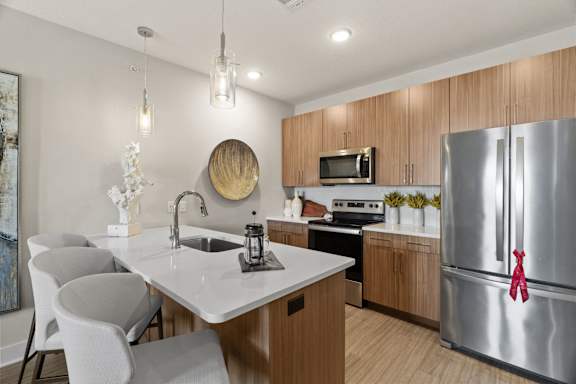 a kitchen with stainless steel appliances and a white counter top
