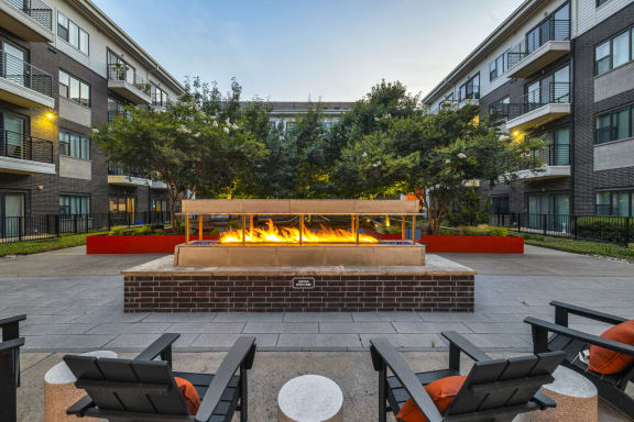 a fire pit in the courtyard of an apartment complex